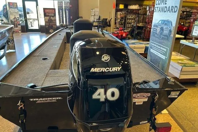 Slide: The Image of 2025 Tracker Panfish 17 boat with Mercury 40 engine displayed in showroom. - 2