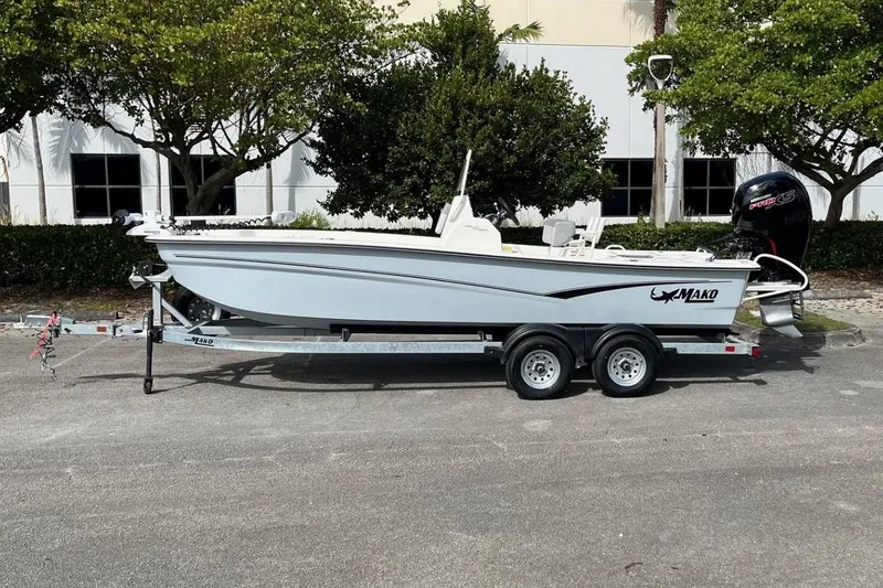 The Image of 2024 Mako Pro Skiff 19 CC boat on trailer, parked outdoors. - 0