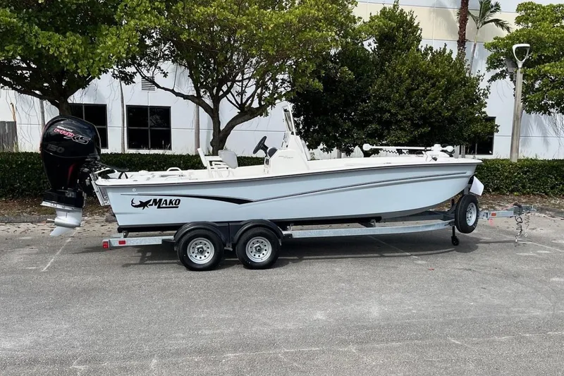 Slide: The Image of 2024 Mako Pro Skiff 19 CC boat on trailer, parked outdoors. - 1