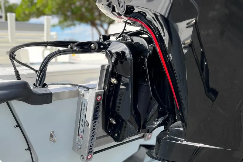 Slide: The Image of 2024 Mako Pro Skiff 19 CC outboard motor detail with hydraulic components. - 12