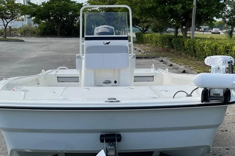Slide: The Image of 2024 Mako Pro Skiff 19 CC boat, parked outdoors, front view. - 3