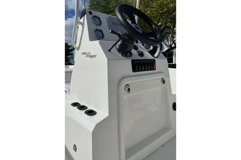 Slide: The Image of 2024 Mako Pro Skiff 19 CC console with steering wheel and gauges. - 6