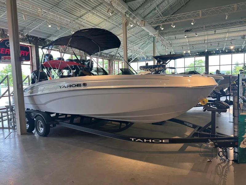 Slide: The Image of 2024 Tahoe T21 boat displayed indoors on a trailer. - 0
