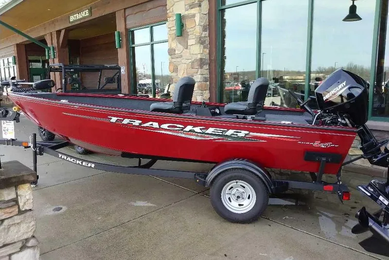 The Image of 2025 Tracker Super Guide V-16 T boat in vibrant red, displayed outdoors. - 0