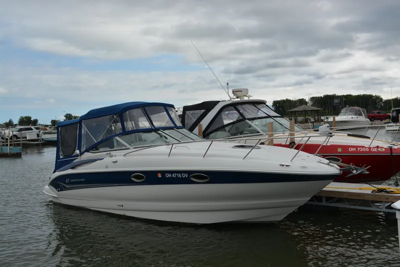 Slide: The Image of 2004 Crownline 270 CR boat docked at marina under cloudy sky. - 0