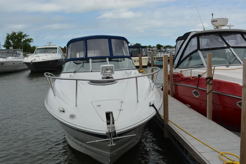 Slide: The Image of 2004 Crownline 270 CR boat docked at marina, surrounded by other boats. - 1