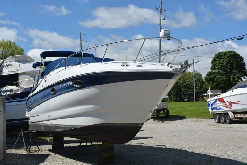 Slide: The Image of 2004 Crownline 270 CR boat on display in a marina, sunny day. - 12