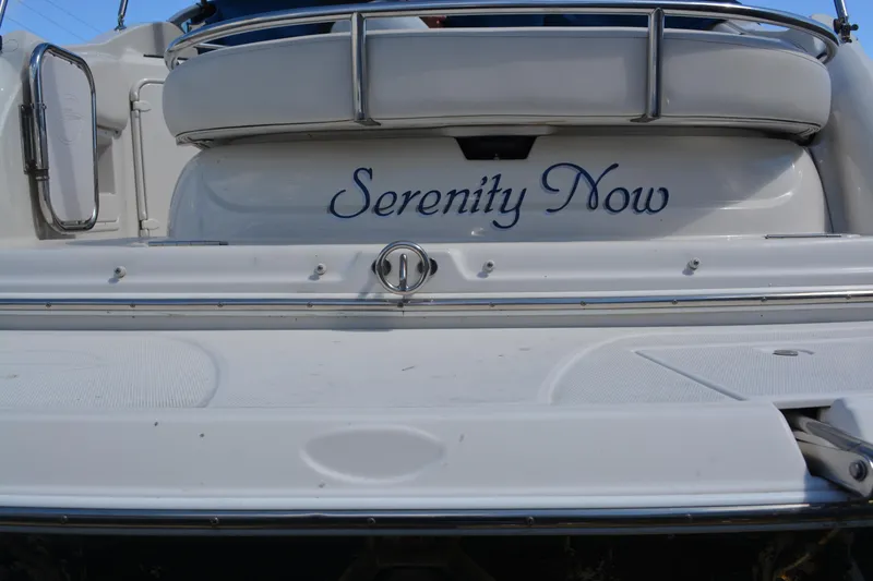 Slide: The Image of 2004 Crownline 270 CR boat with "Serenity Now" name on the stern. - 14