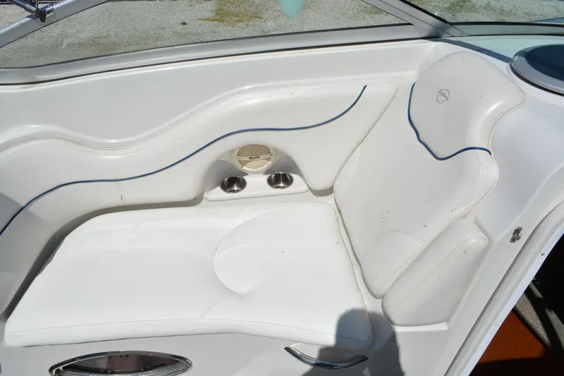 Slide: The Image of 2004 Crownline 270 CR boat interior with white seating and cup holders. - 16