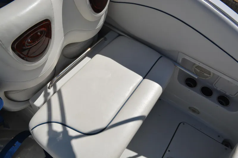 Slide: The Image of 2004 Crownline 270 CR boat interior with white seating and speaker system. - 18