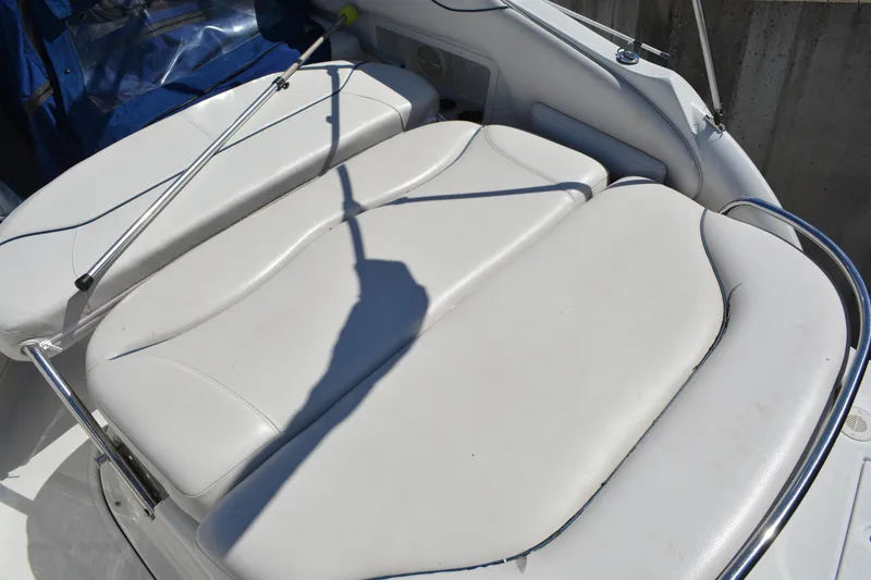 Slide: The Image of 2004 Crownline 270 CR boat with white cushioned seating area. - 19