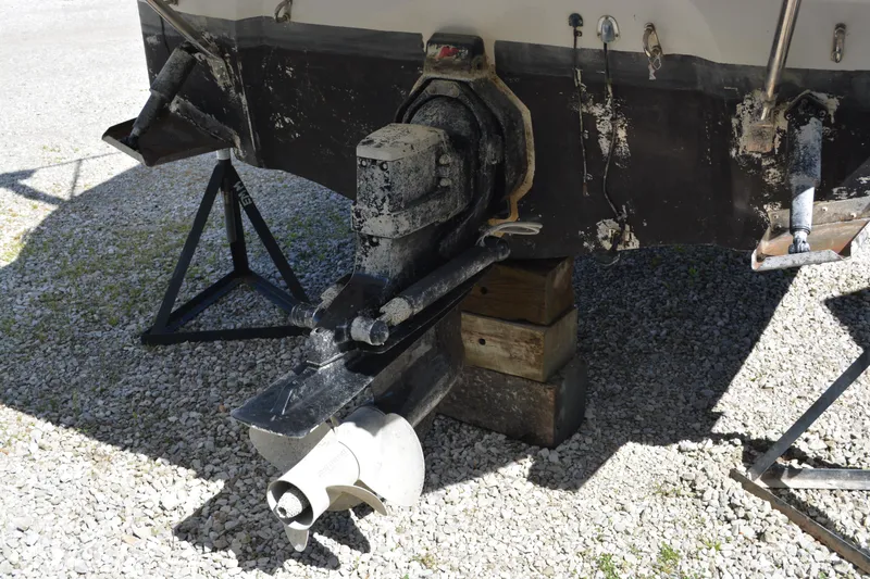 Slide: The Image of 2004 Crownline 270 CR boat stern drive on gravel, supported by blocks and stands. - 22
