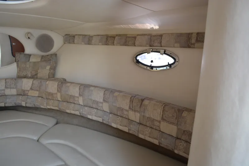 Slide: The Image of 2004 Crownline 270 CR cabin interior with patterned seating and oval window. - 25