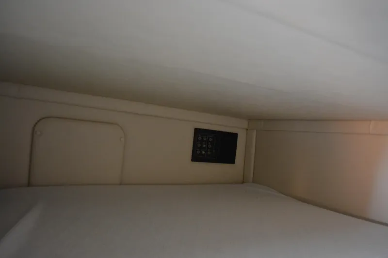 Slide: The Image of Interior cabin of 2004 Crownline 270 CR boat, featuring a compact sleeping area. - 30