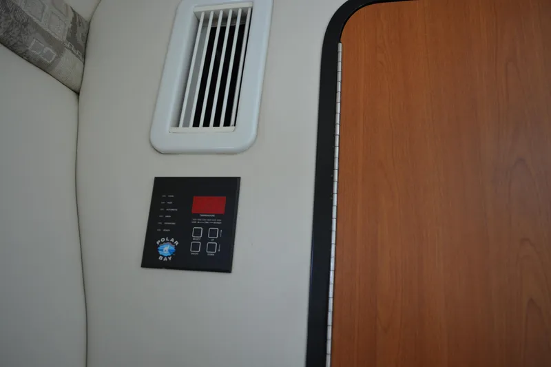Slide: The Image of Interior of 2004 Crownline 270 CR boat showing control panel and vent. - 33