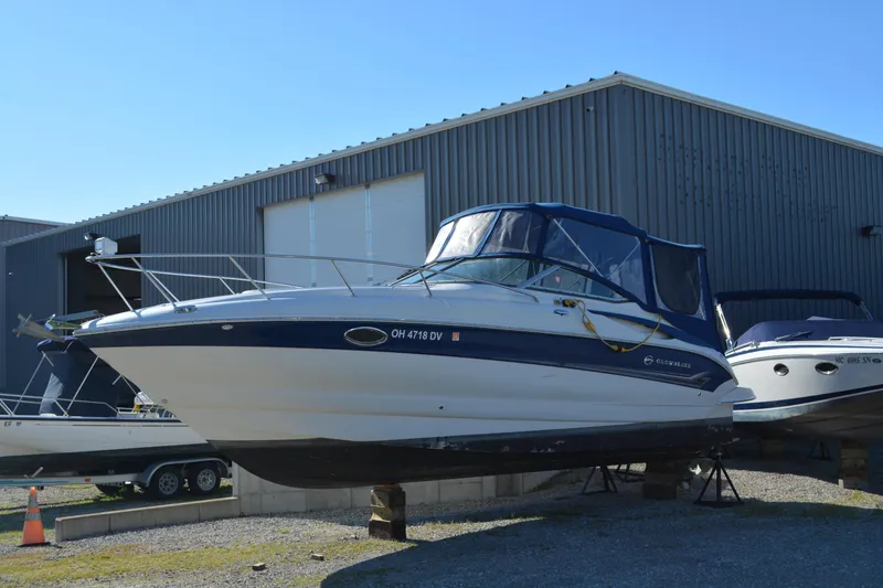 Slide: The Image of 2004 Crownline 270 CR boat on display outside a warehouse. - 8