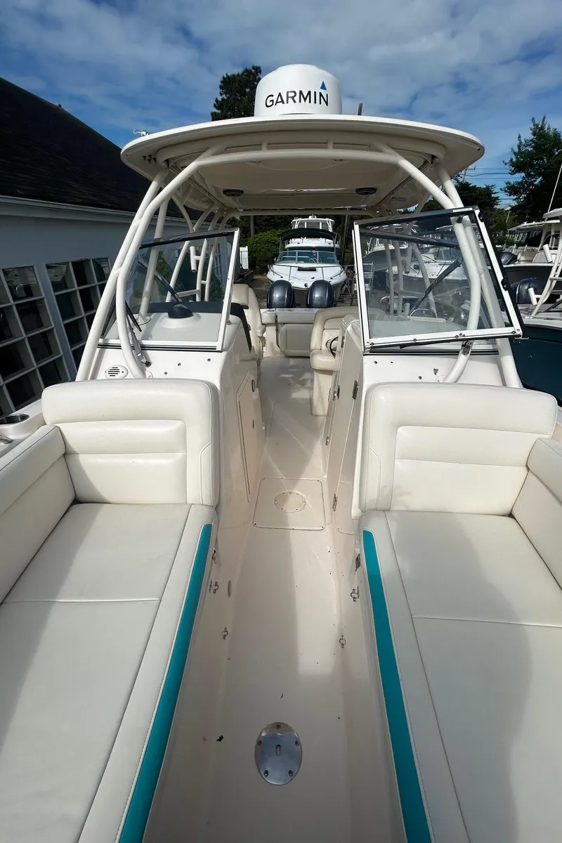 Slide: The Image of 2017 Grady-White Freedom 275 boat interior with Garmin equipment, featuring spacious seating and open deck. - 14