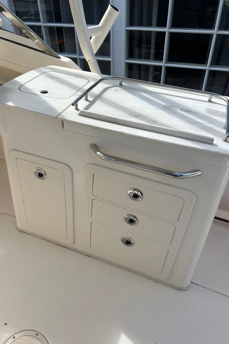 Slide: The Image of 2017 Grady-White Freedom 275 boat interior with storage compartments and sleek design. - 16