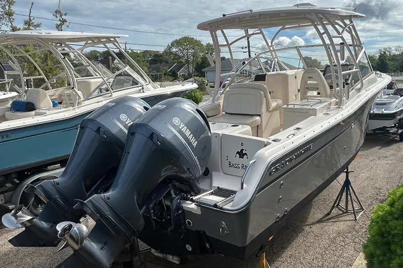 Slide: The Image of 2017 Grady-White Freedom 275 boat with dual Yamaha engines, docked outdoors. - 5