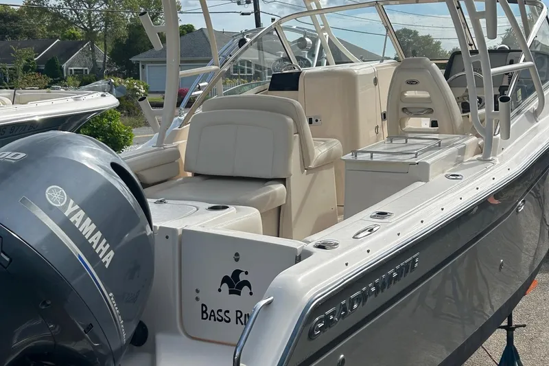 Slide: The Image of 2017 Grady-White Freedom 275 boat with Yamaha engine, docked outdoors. - 6