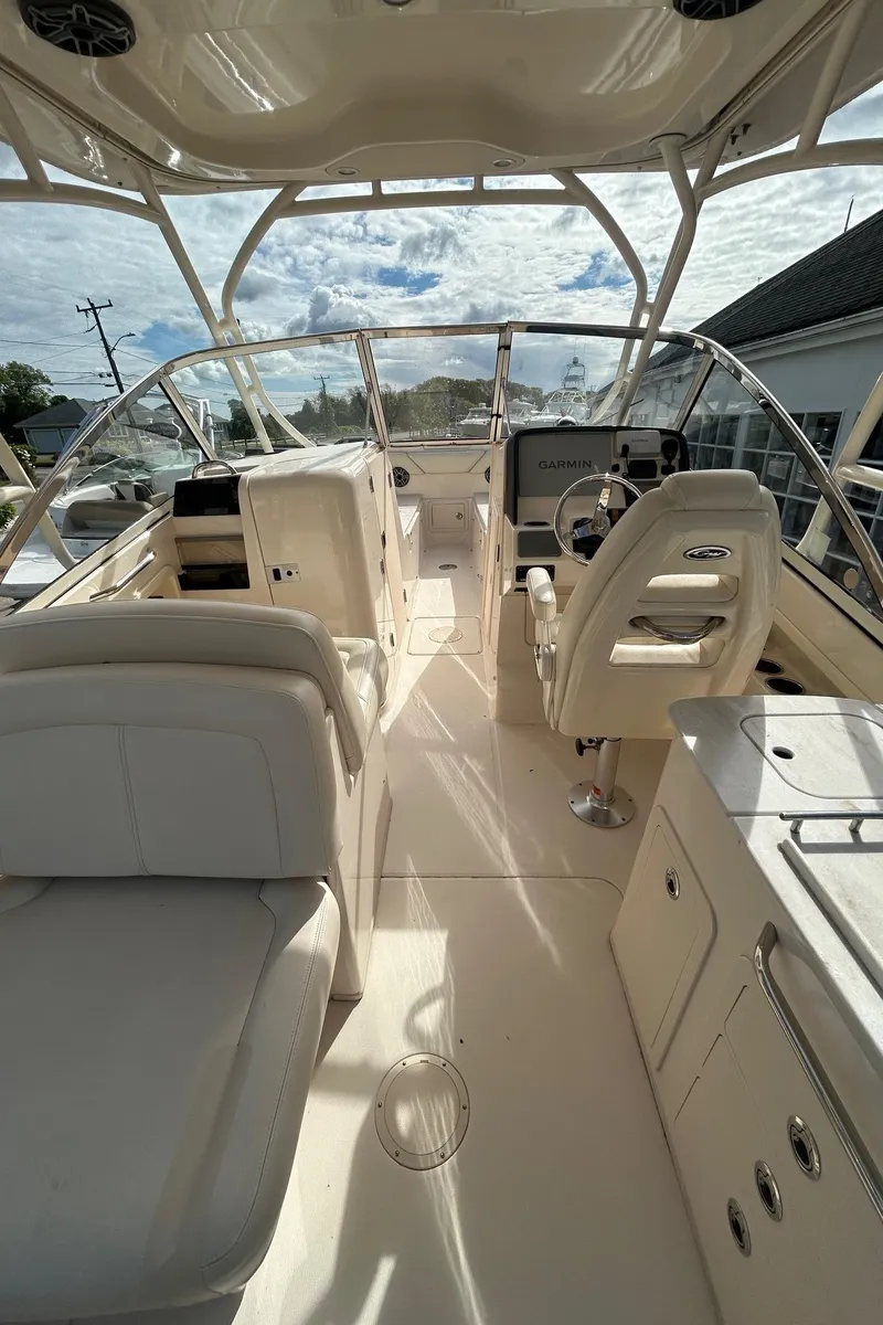 Slide: The Image of 2017 Grady-White Freedom 275 boat interior with seating and helm. - 8