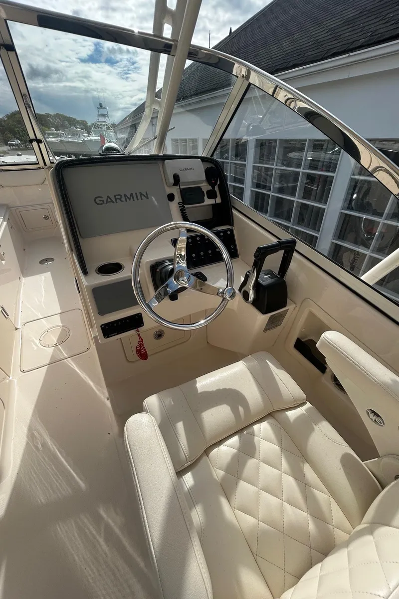 Slide: The Image of 2017 Grady-White Freedom 275 boat interior with Garmin navigation system and luxurious seating. - 9