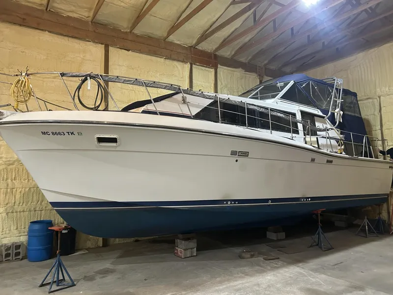 The Image of 1988 Chris-Craft 381 Catalina boat in storage, showcasing sleek design and sturdy build. - 1
