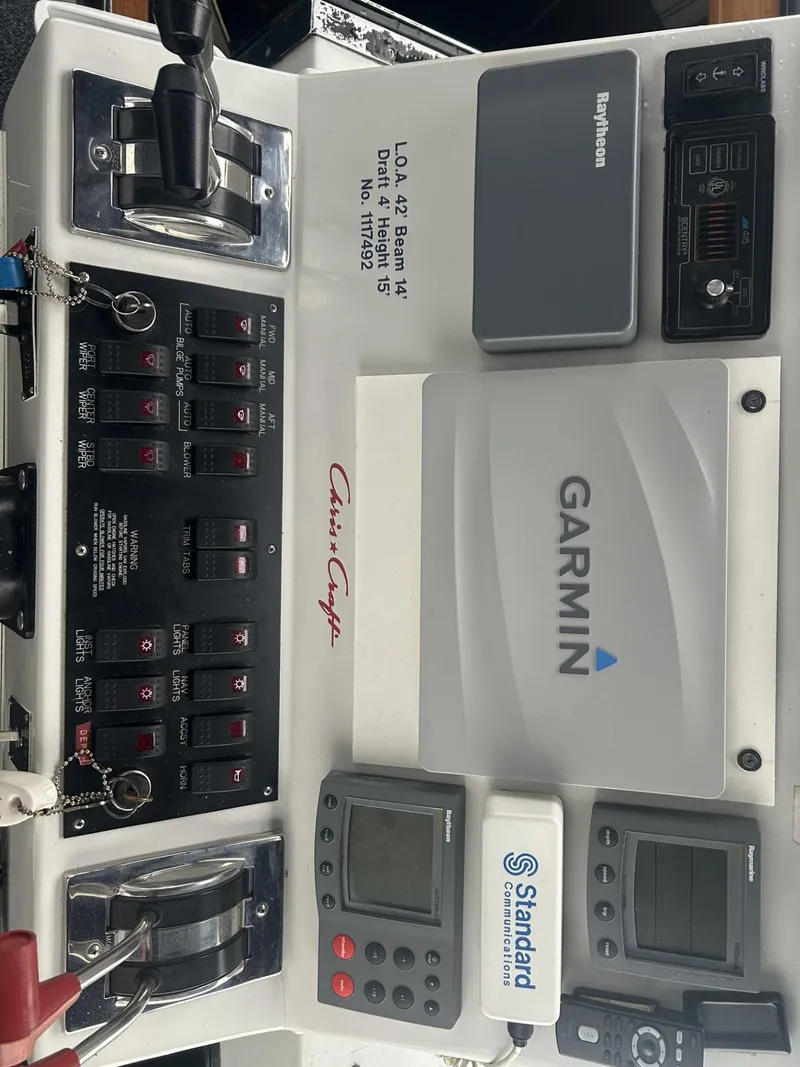 Slide: The Image of 1988 Chris-Craft 381 Catalina dashboard with Garmin and Raytheon navigation systems. - 12
