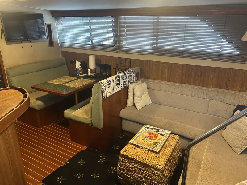 Slide: The Image of Interior of 1988 Chris-Craft 381 Catalina yacht with cozy seating and wooden accents. - 17