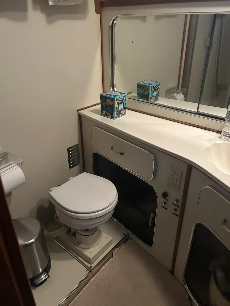 Slide: The Image of Bathroom interior of 1988 Chris-Craft 381 Catalina yacht, featuring toilet and vanity. - 22