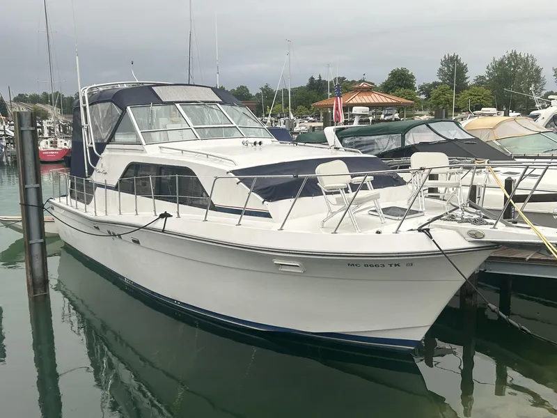 Slide: The Image of 1988 Chris-Craft 381 Catalina yacht docked in a marina, featuring sleek design and spacious deck. - 9