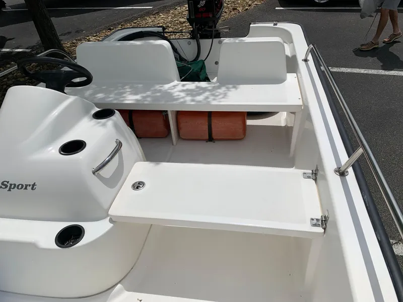 Slide: The Image of 2005 Boston Whaler 150 Sport boat interior with seating and storage compartments. - 3