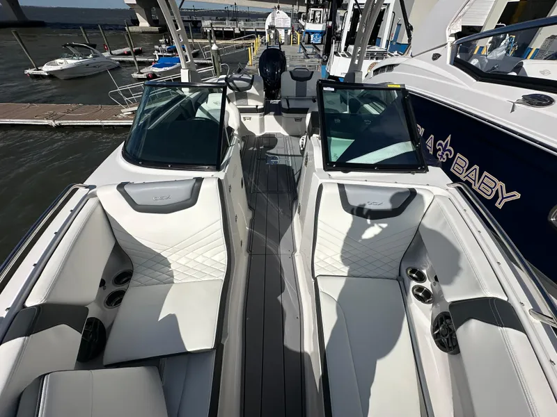 Slide: The Image of 2023 Chaparral 250 OSX boat interior with sleek white seating and modern design. - 15