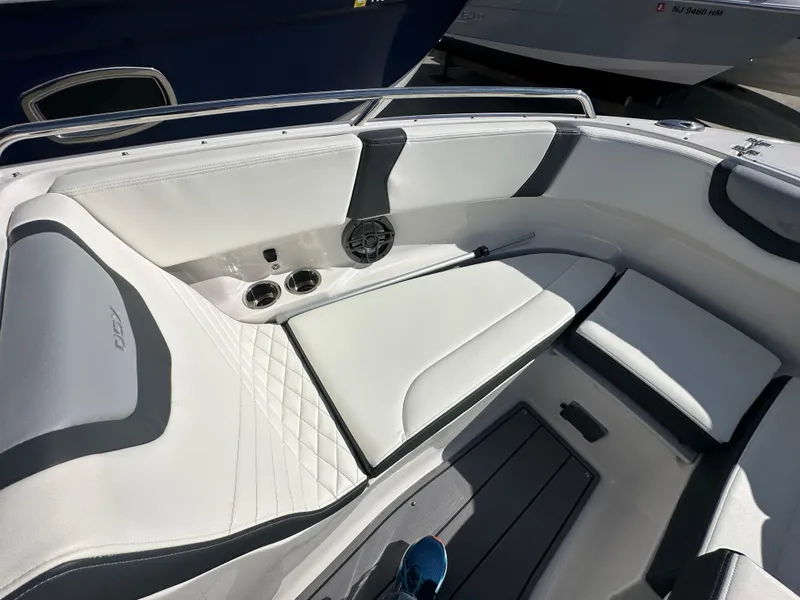 Slide: The Image of 2023 Chaparral 250 OSX boat interior with white seating and cup holders. - 18