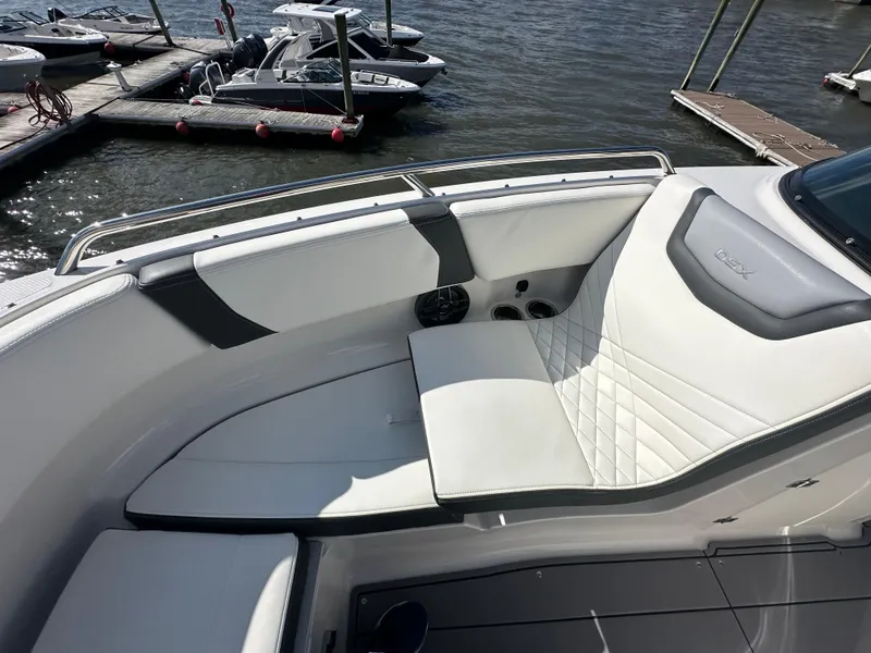 Slide: The Image of 2023 Chaparral 250 OSX boat interior with sleek seating and modern design. - 19
