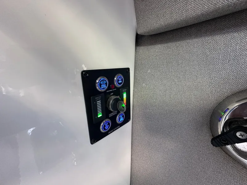 Slide: The Image of Control panel on 2023 Chaparral 250 OSX boat, featuring illuminated gauges and switches. - 24