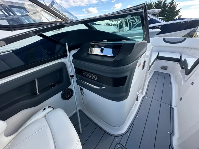 Slide: The Image of 2023 Chaparral 250 OSX boat interior with sleek design and modern controls. - 27