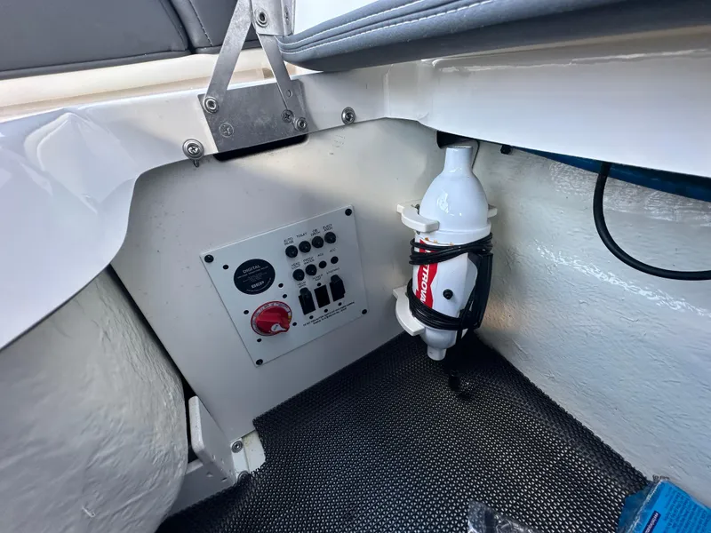 Slide: The Image of 2023 Chaparral 250 OSX boat interior with control panel and fire extinguisher. - 33