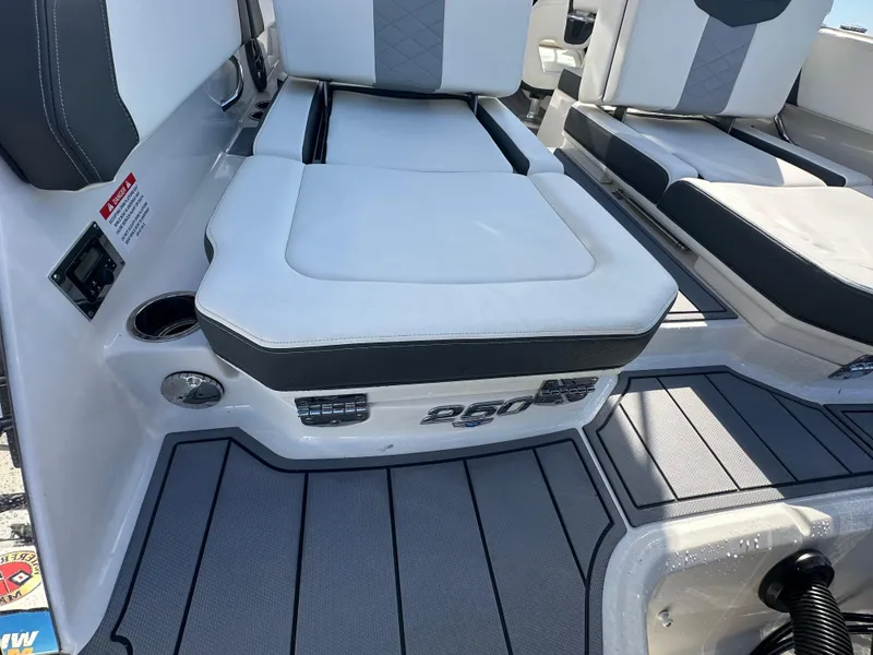 Slide: The Image of 2023 Chaparral 250 OSX boat interior with cushioned seating and sleek design. - 39