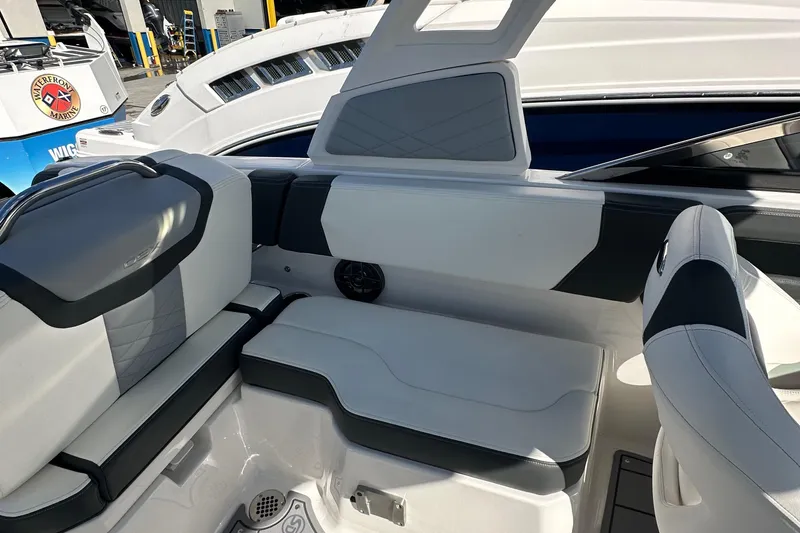 Slide: The Image of 2023 Chaparral 250 OSX boat interior with sleek seating and modern design. - 43