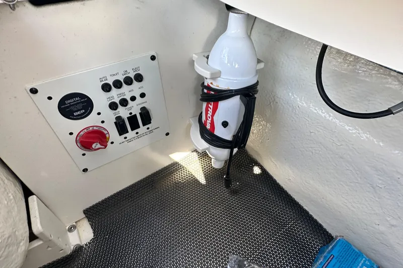 Slide: The Image of Control panel and fire extinguisher in 2023 Chaparral 250 OSX boat interior. - 45