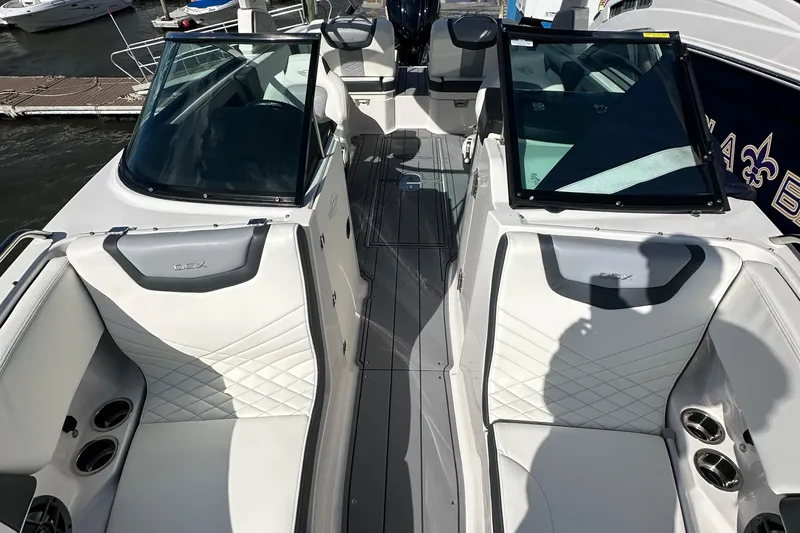 Slide: The Image of 2023 Chaparral 250 OSX boat interior with white seating and sleek design. - 49