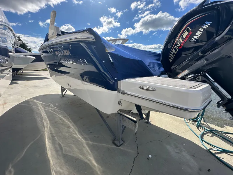 Slide: The Image of 2023 Chaparral 250 OSX boat with Yamaha engine, docked under a sunny sky. - 5