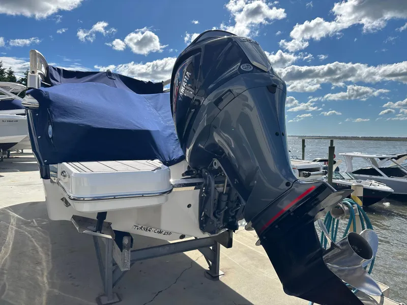 Slide: The Image of 2023 Chaparral 250 OSX boat with covered deck and powerful outboard motor. - 6