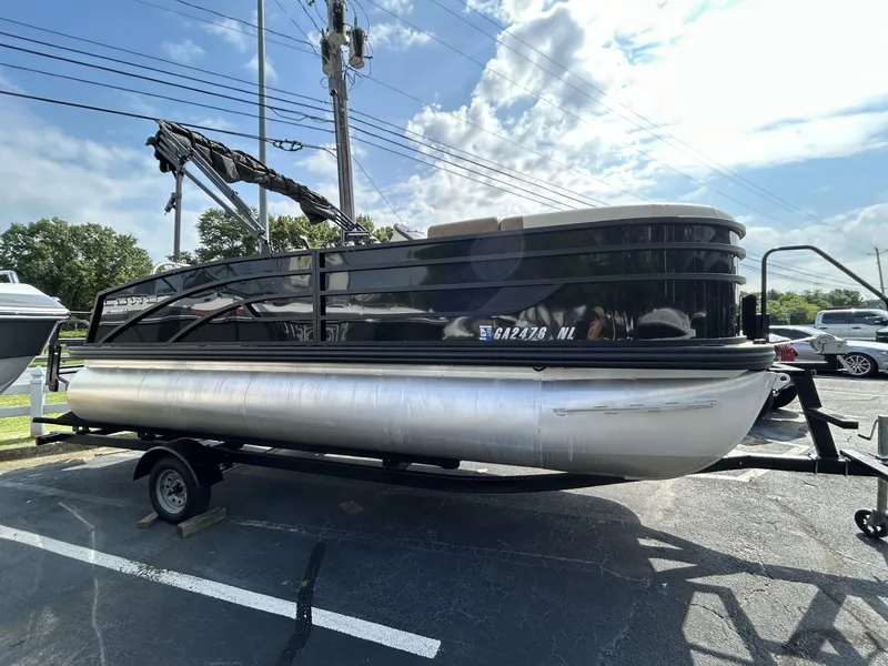 Slide: The Image of 2022 Lowe 190 SS pontoon boat on trailer under a clear blue sky. - 1