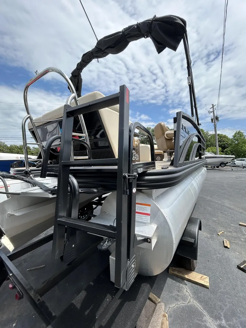 Slide: The Image of 2022 Lowe 190 SS pontoon boat on trailer, featuring sleek design and comfortable seating. - 13