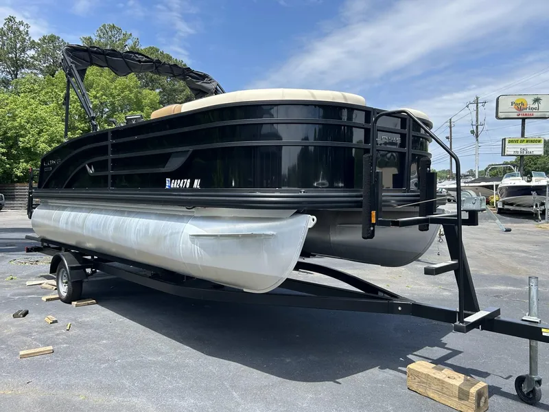 Slide: The Image of 2022 Lowe 190 SS pontoon boat on trailer in outdoor setting. - 2