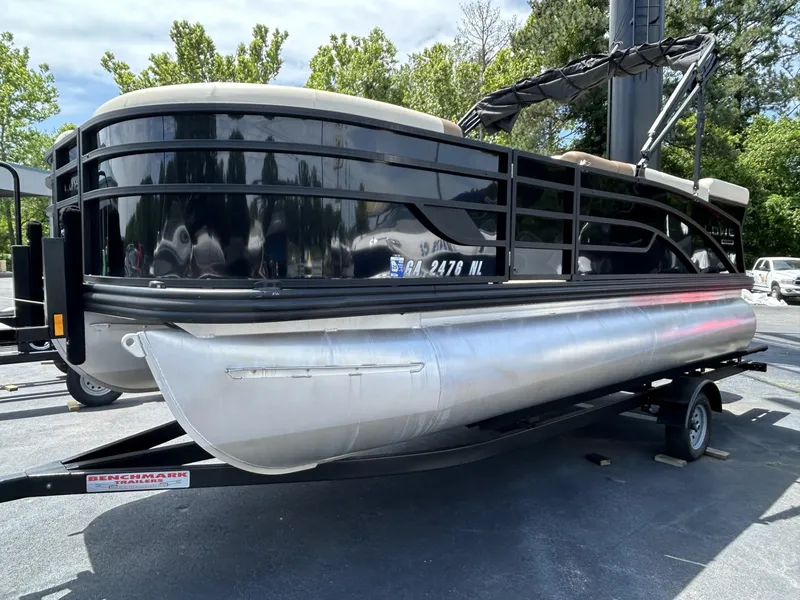 Slide: The Image of 2022 Lowe 190 SS pontoon boat on trailer, black exterior, parked outdoors. - 3