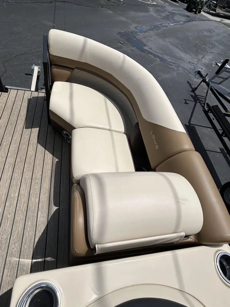 Slide: The Image of 2022 Lowe 190 SS boat with beige and brown seating on a wooden deck. - 4