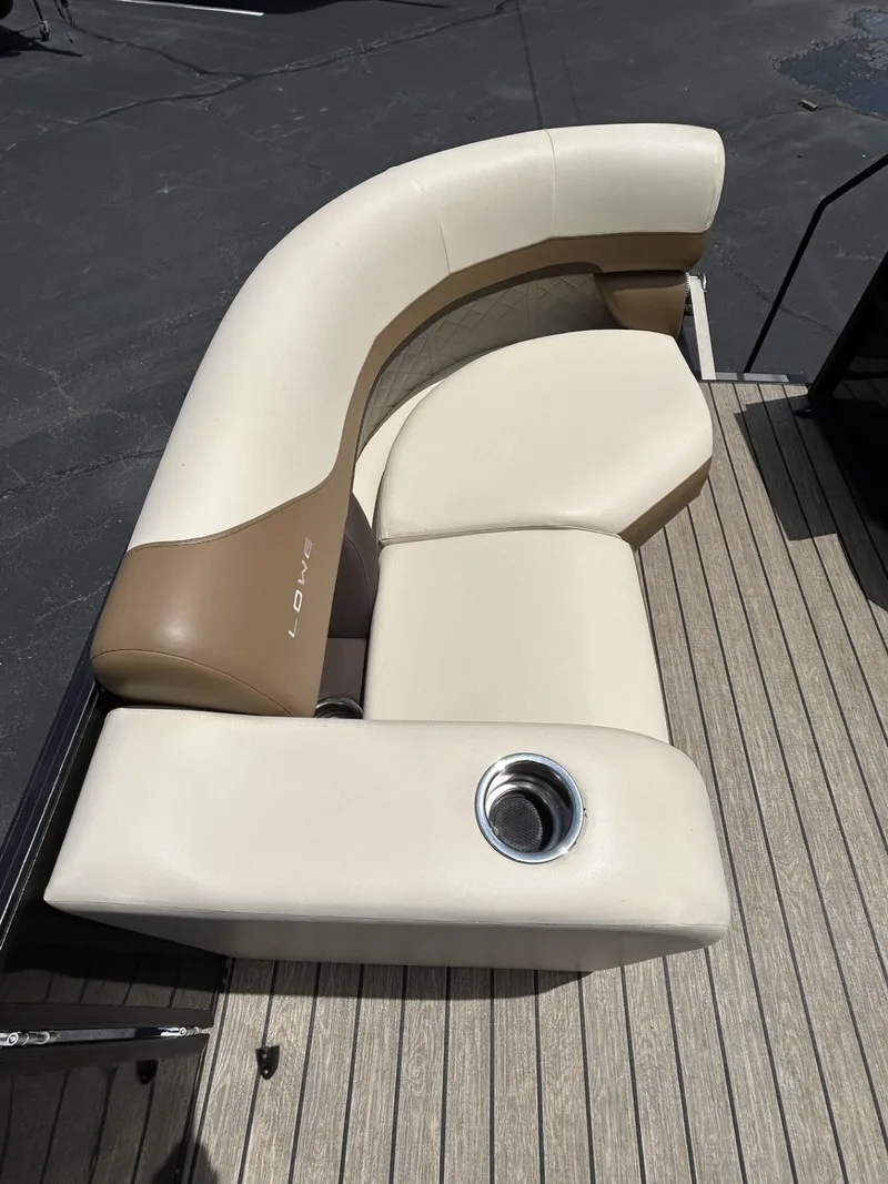 Slide: The Image of 2022 Lowe 190 SS boat seating with beige and brown upholstery, featuring a built-in cup holder. - 5